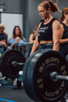  Ladies black vest on model lifting weights