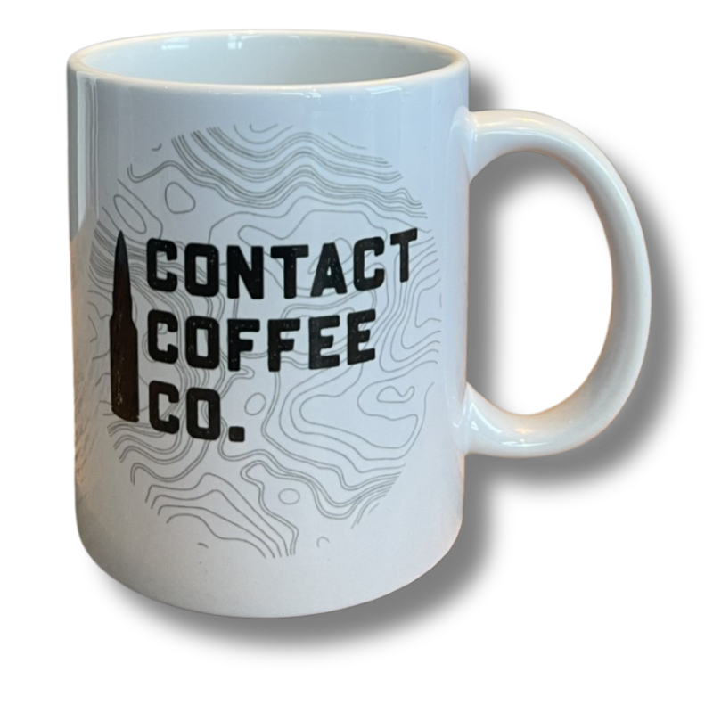 White mug with Contact Coffee bullet logo and topographical lines